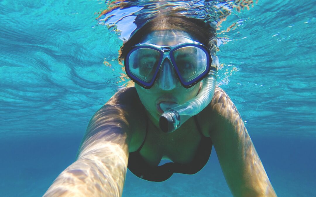 woman wearing water goggles underwater